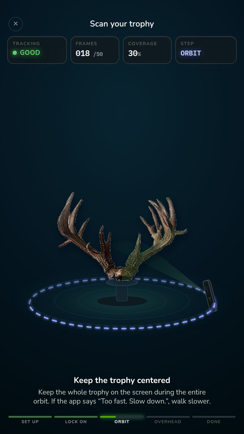 The scan guide's orbit step: a phone partway around whitetail antlers on a stand